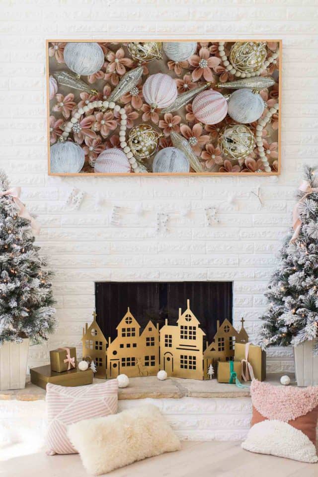 photo of a frame tv above a christmas fireplace