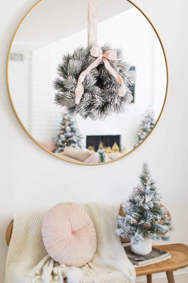 christmas wreath on a mirror with bench