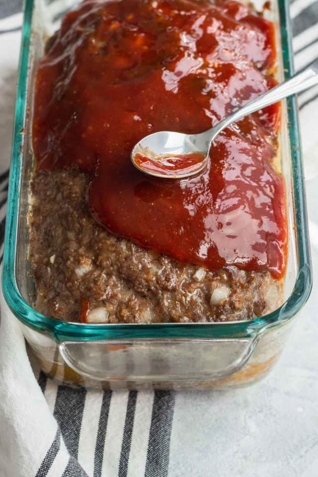 photo of the sauce being covered on the best meatloaf recipe photo of the recipe card for the best easy meatloaf by top Houston lifestyle blogger Ashley Rose of Sugar & Cloth