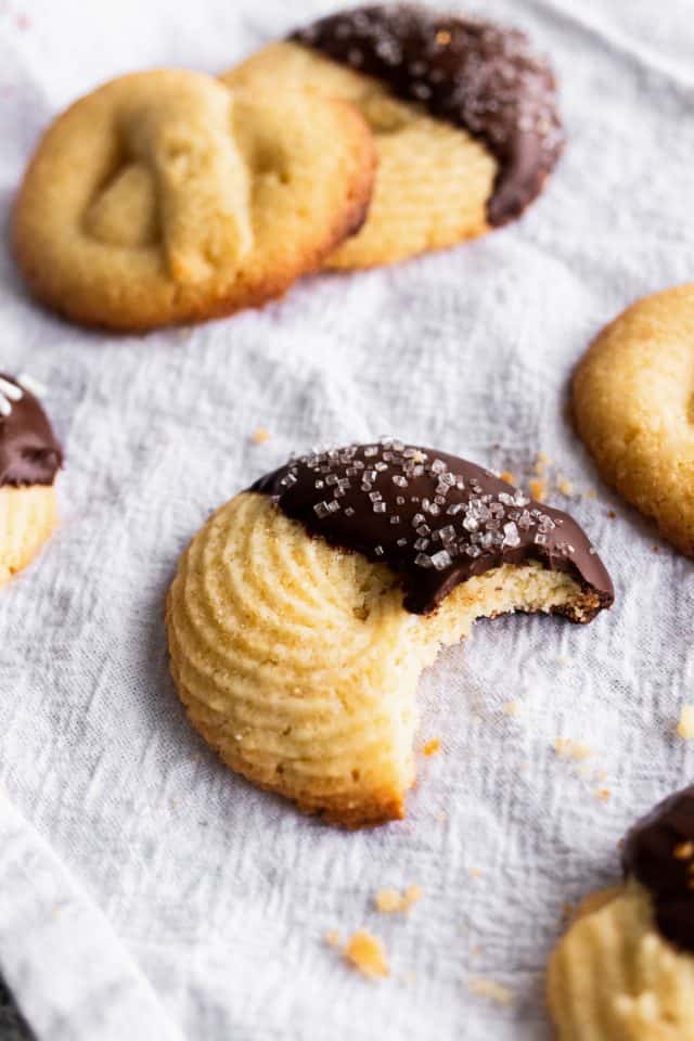 close up photo of a bite of the easy butter cookie dipped in chocolate with sugar sprinkles by top Houston lifestyle blogger Ashley Rose of Sugar & Cloth