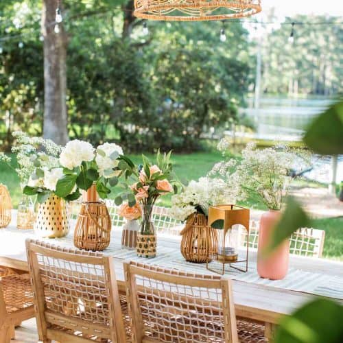 a pretty table scene in the backyard with a basket patio light