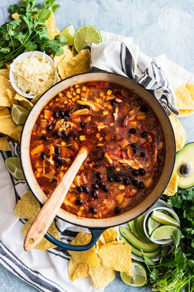 photo of how to serve easy chicken tortilla soup at a party with a topping and serving spread by top Houston lifestyle blogger Ashley Rose of Sugar & Cloth