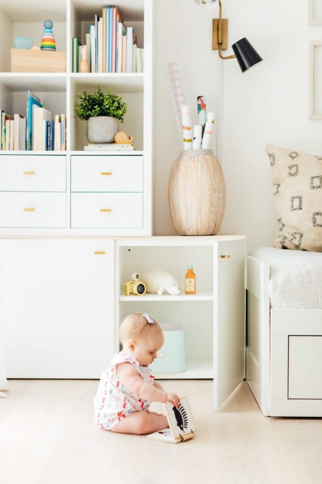 playroom ideas - baby with a baby book in playroom