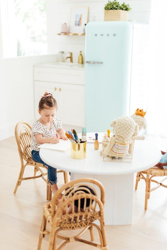 playroom ideas - little girl at a DIY kids table in a playroom