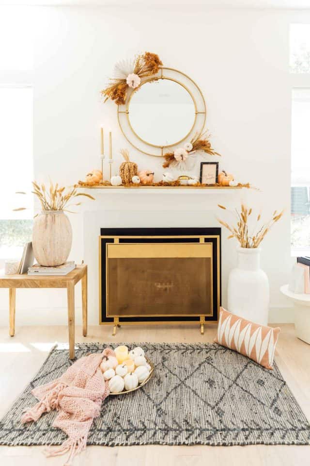 a fireplace with fall pumpkins and styling 