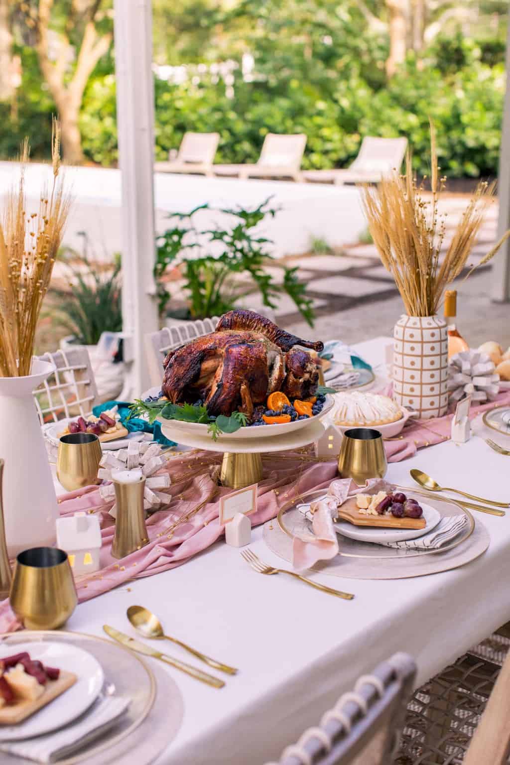 an angled photo of a thanksgiving table in the backyard