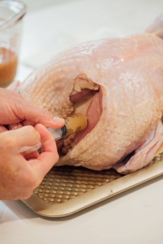 injecting a Belcampo whole turkey with mairnade