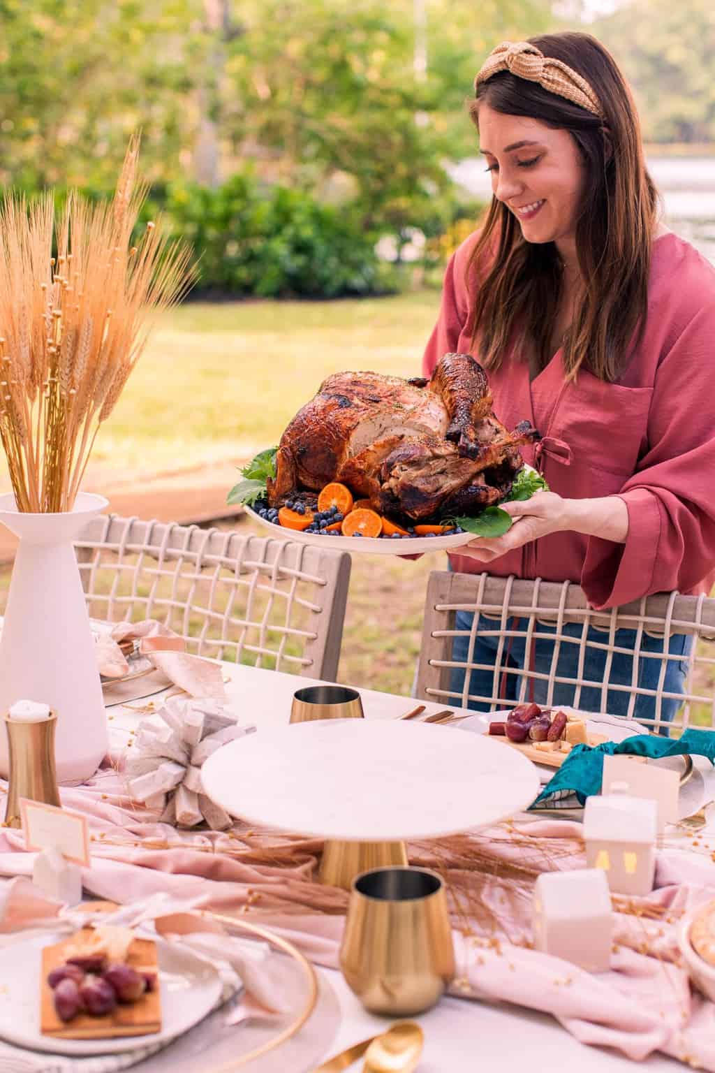a girl holding a plated air fryer turkey recipe by a thanksgiving table