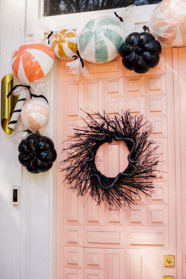 black halloween wreath and pink front door