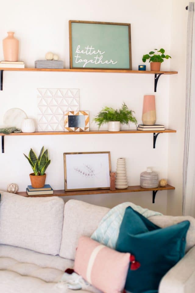 styled bookshelves behind a sofa