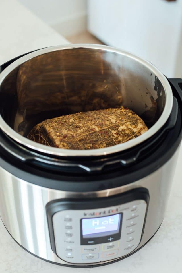 photo of how to cook a pork loin roast in the Instant Pot by top Houston lifestyle blogger Ashley Rose of Sugar & Cloth