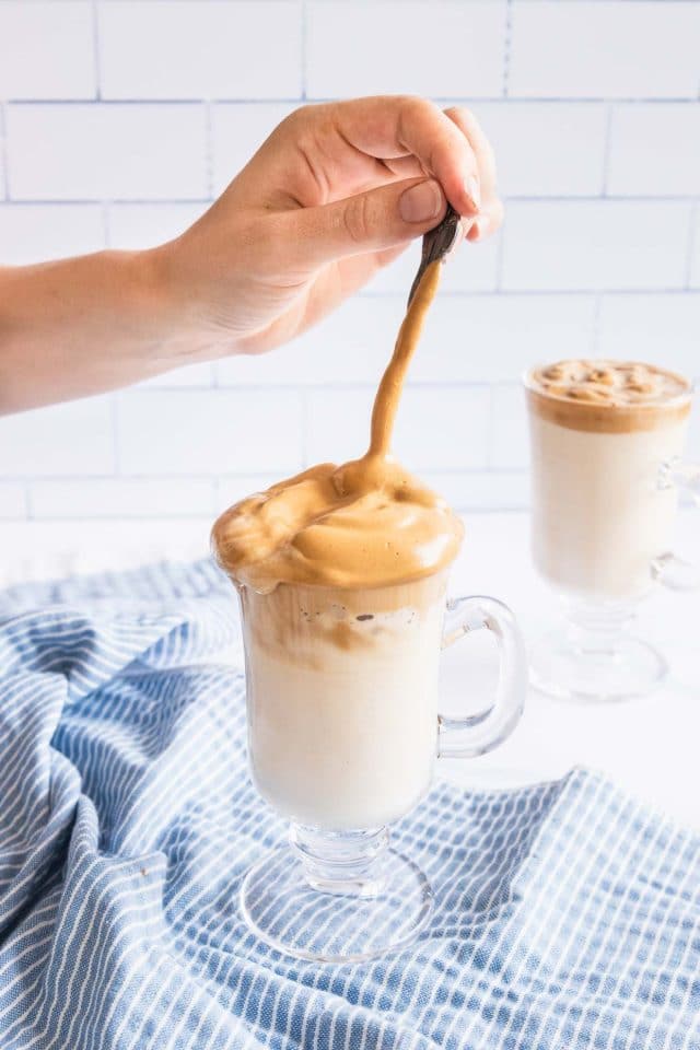 photo of the whipped coffee being stirred by top Houston lifestyle blogger Ashley Rose of Sugar & Cloth