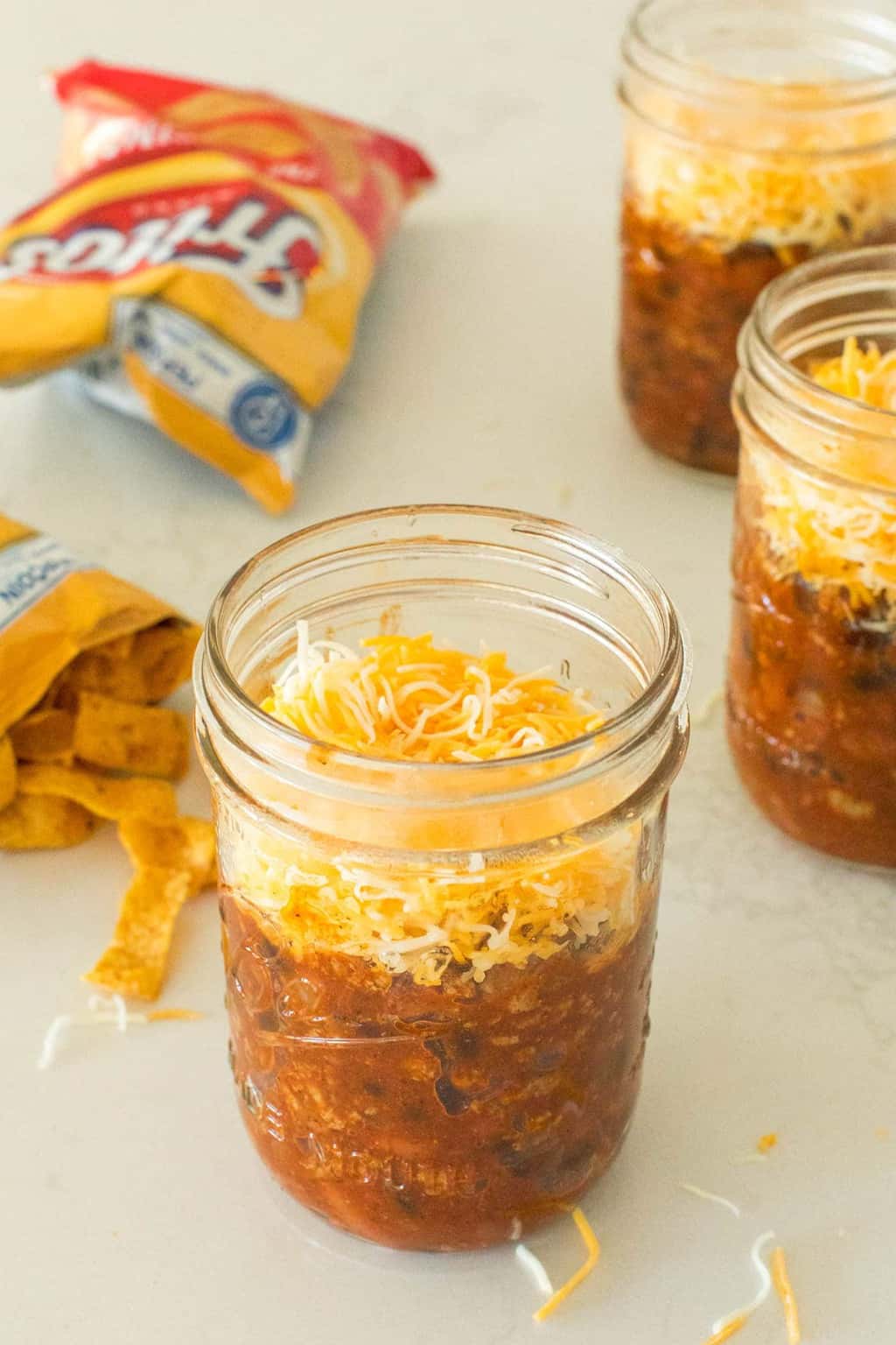 photo of the frito pie being assembled in a mason jar by top Houston lifestyle blogger Ashley Rose of Sugar & Cloth