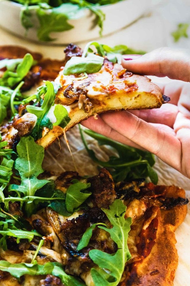 photo the delicious keto pizza crust sliced and topped with keto topping by top Houston lifestyle blogger Ashley Rose of Sugar & Cloth
