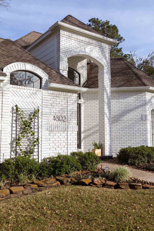 angled photo of an exterior limewash paint job on brick