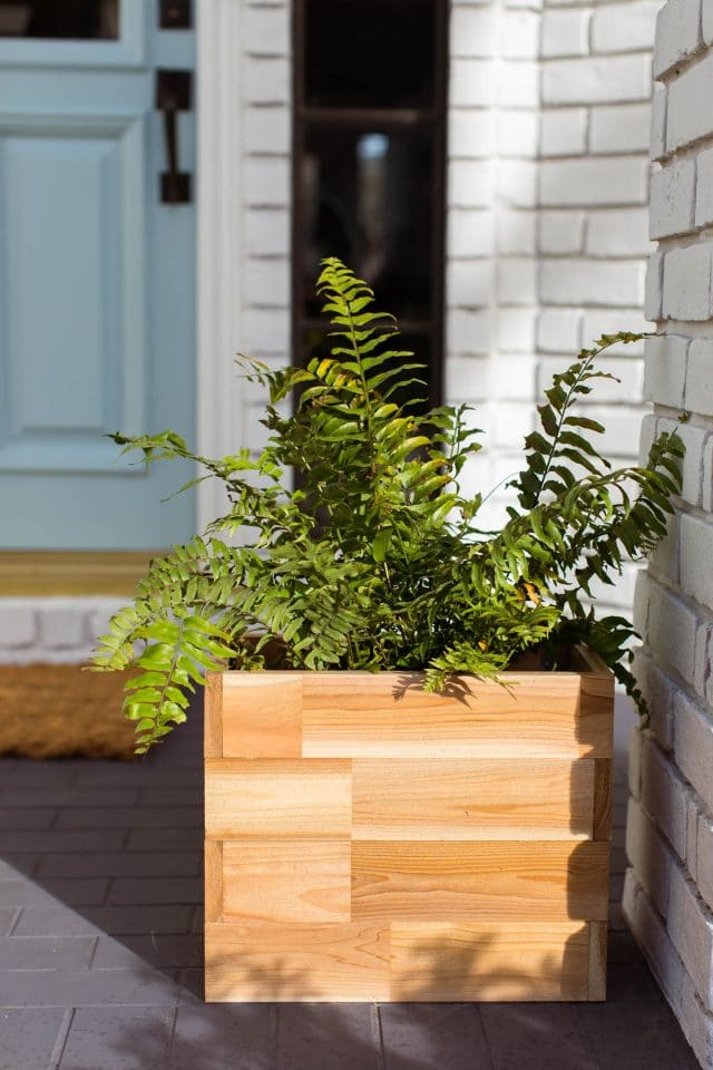 a cedar wood planter on a front porch