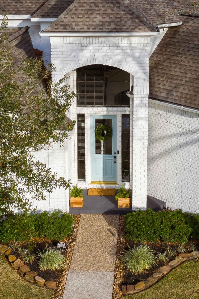 drone photo of an updated exterior brick house entrance