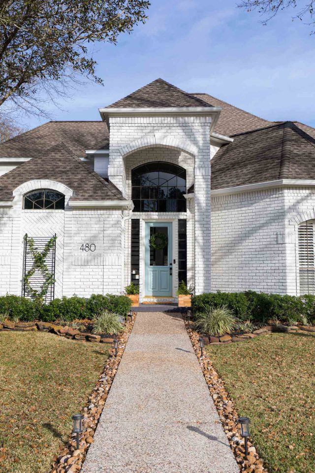 entrance of a white house exterior with blue using limewash paint