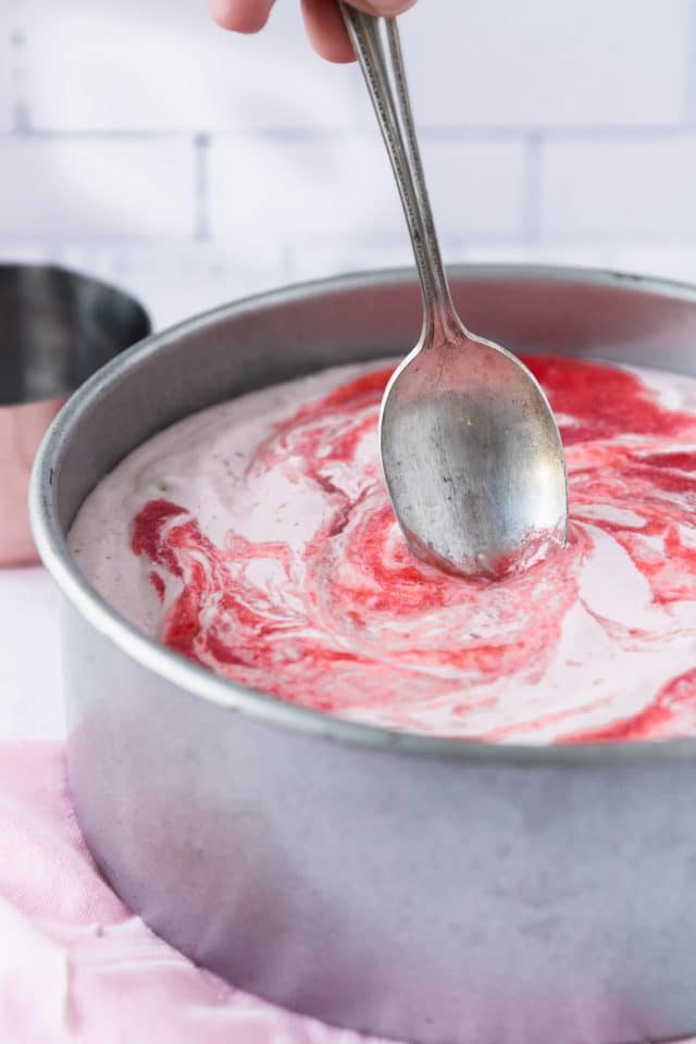 photo of the strawberry puree being added into the low carb cheesecake by top Houston lifestyle blogger Ashley Rose of Sugar & Cloth