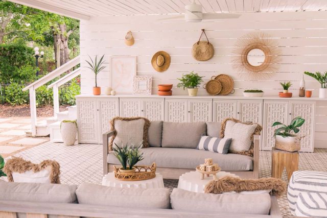 horizontal photo of outdoor sofas and cabinets in styled setting