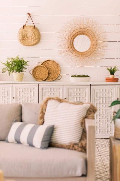 outdoor sofa cushions in front of shiplap outdoor walls