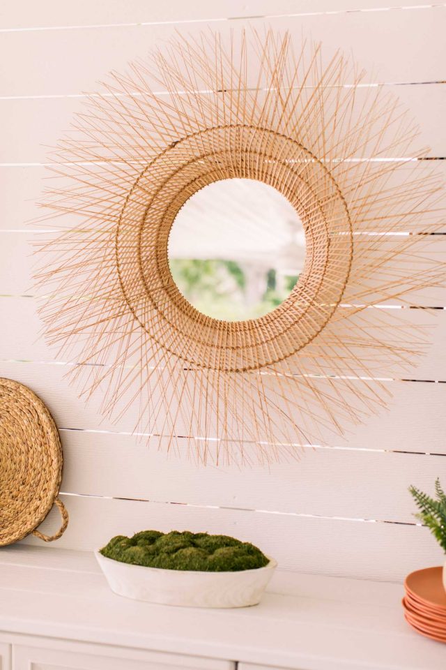 rattan wicker mirror on a shiplap wall