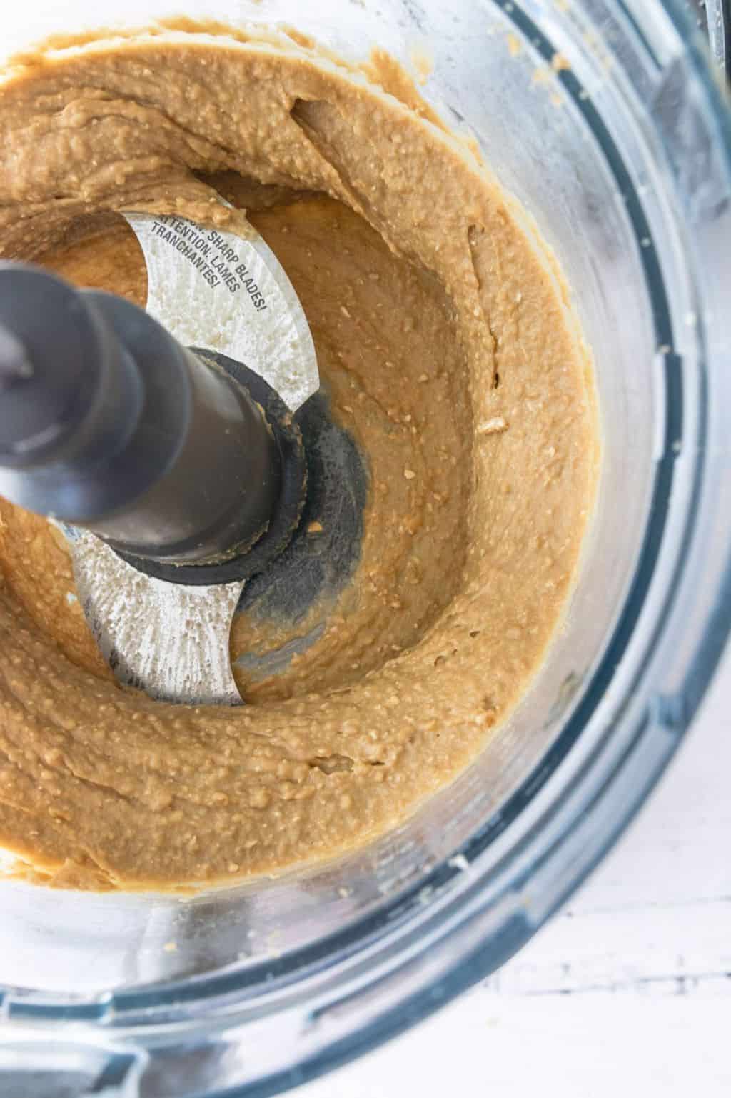 Grind Chickpeas, nut butter, sweetener, salt, baking powder, and oats, and vanilla extract in the bowl of a food processor for the Chickpea Cookie Dough