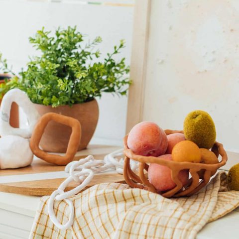 photo of the sculptures, chain link decor and fruit bowls made from Sculpey polymer clay by top Houston lifestyle blogger Ashley Rose of Sugar & Cloth