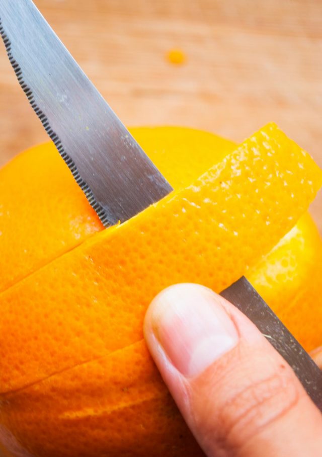 Best Amaretto Sour Recipe - a photo of how to peel the orange.