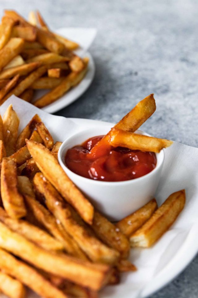 best french fries - 2 slices of french fries dipped on a ketchup