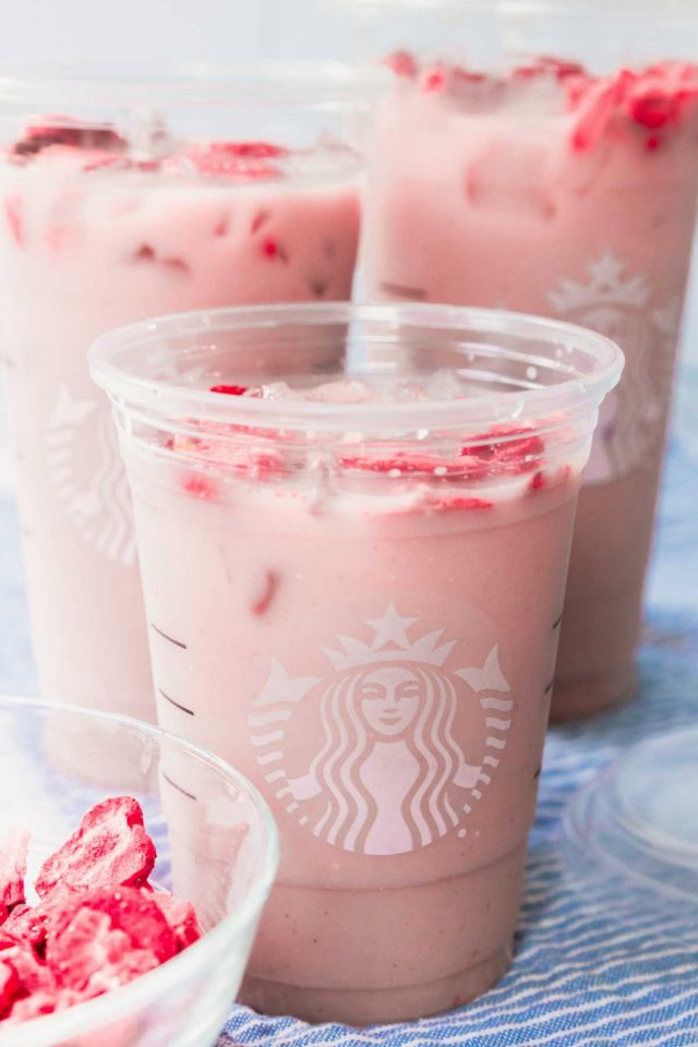 how to make the pink drink from starbucks - a close up shot of the 3 different cup sizes of the pink drinks