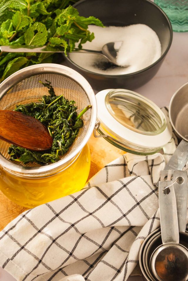 mint simple syrup recipe - mesh strainer full of mint