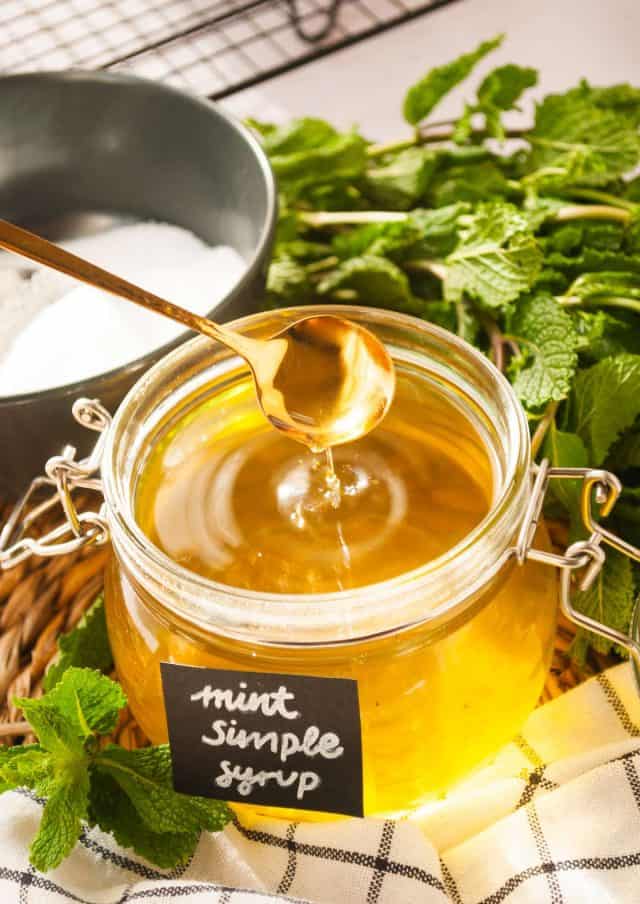 mint infused simple syrup - freshly made mint with spoon