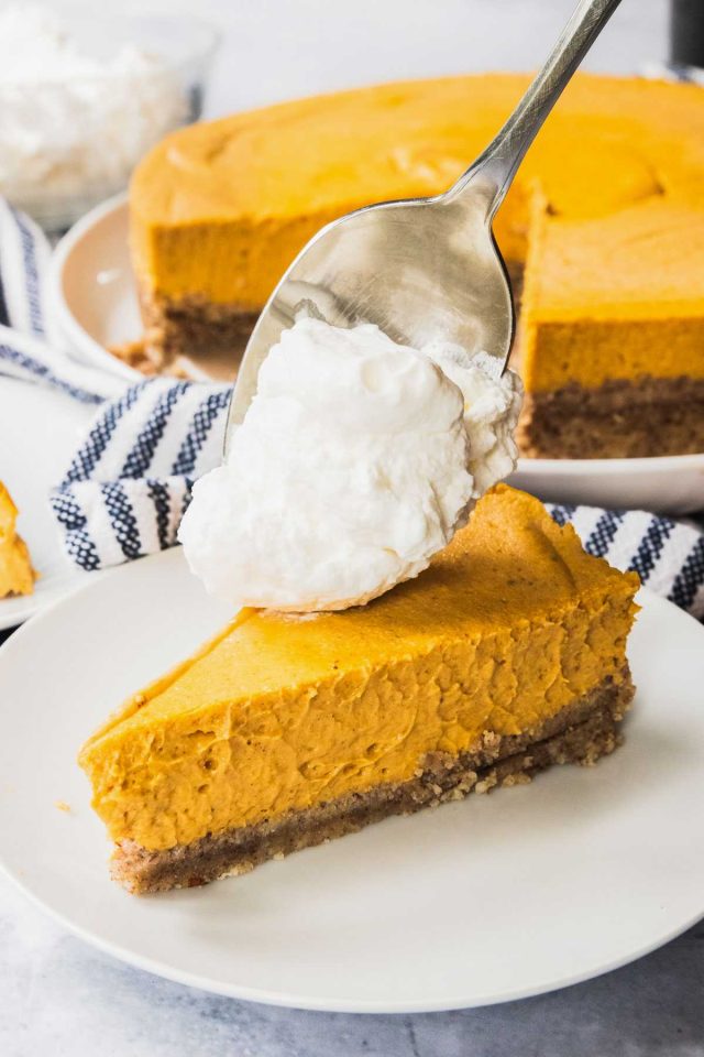 low carb pumpkin cheesecake - putting whipping cream on top of cheesecake