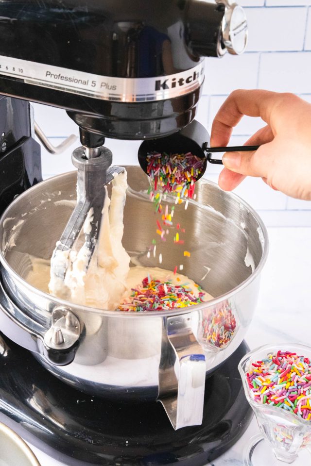 birthday cheesecake - photo of the Funfetti sprinkles being poured in the cake batter