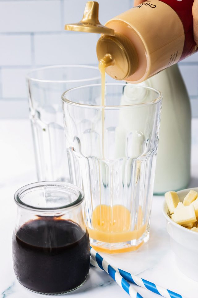 starbucks white chocolate mocha - pouring white chocolate syrup in a glass