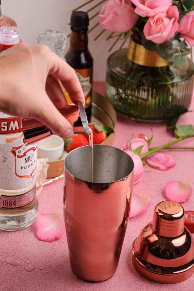 rose syrup cocktail - pouring ingredients in a cocktail shaker