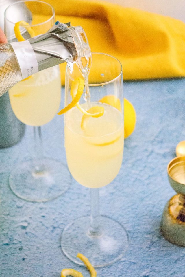 how to make a french 75 - pouring champagne in a serving glass