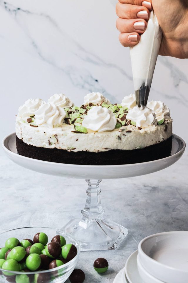 decorating the cheesecake - topping it with whipped cream