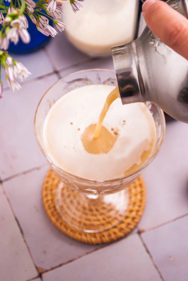 Pouring Brandy Alexander into the coupe glass