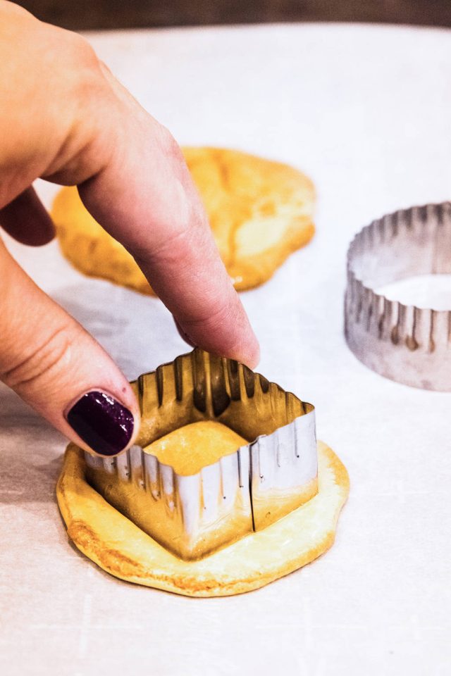  pressing into the dalgona candy center with a small cookie cutter