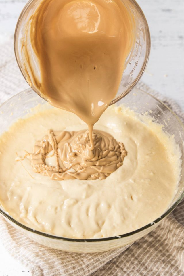 Adding the melted Caramilk chocolate to the cheesecake filling