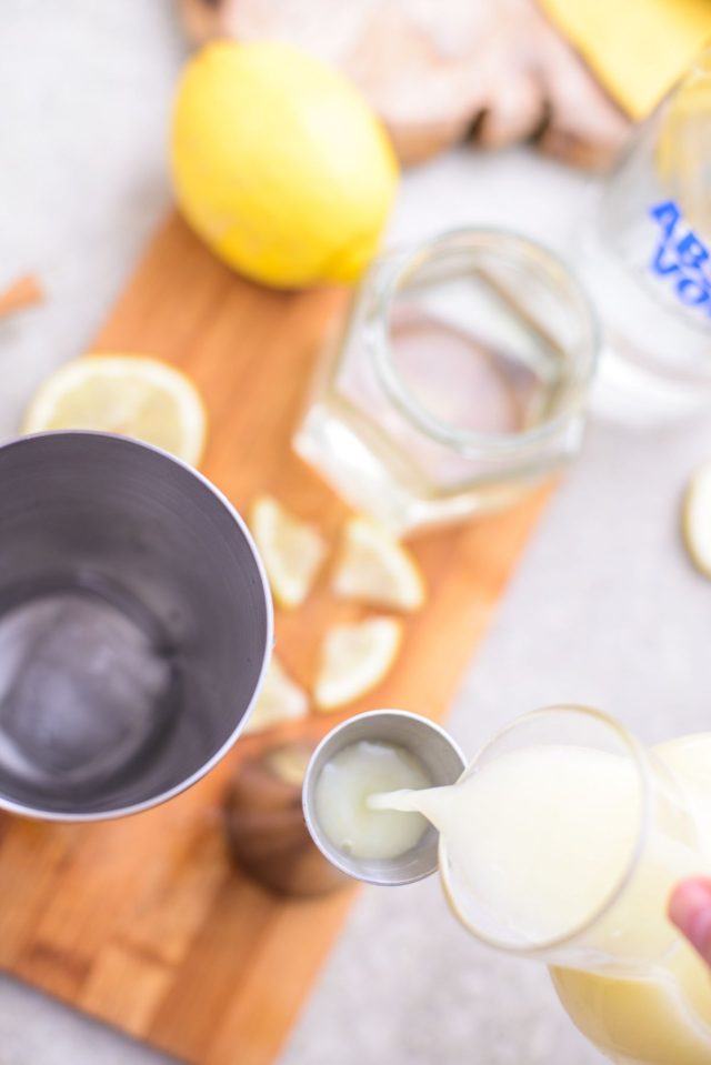 pouring lemonade in a container - how to make a lemon drop by Ashley Rose of sugar & cloth