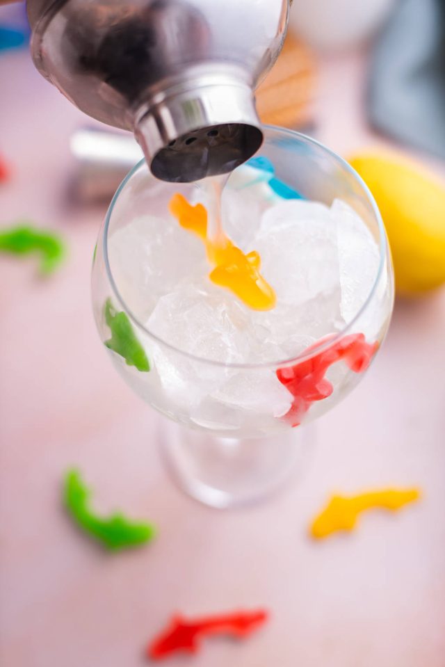 Pouring the cocktail into the glass for the fish bowl drink