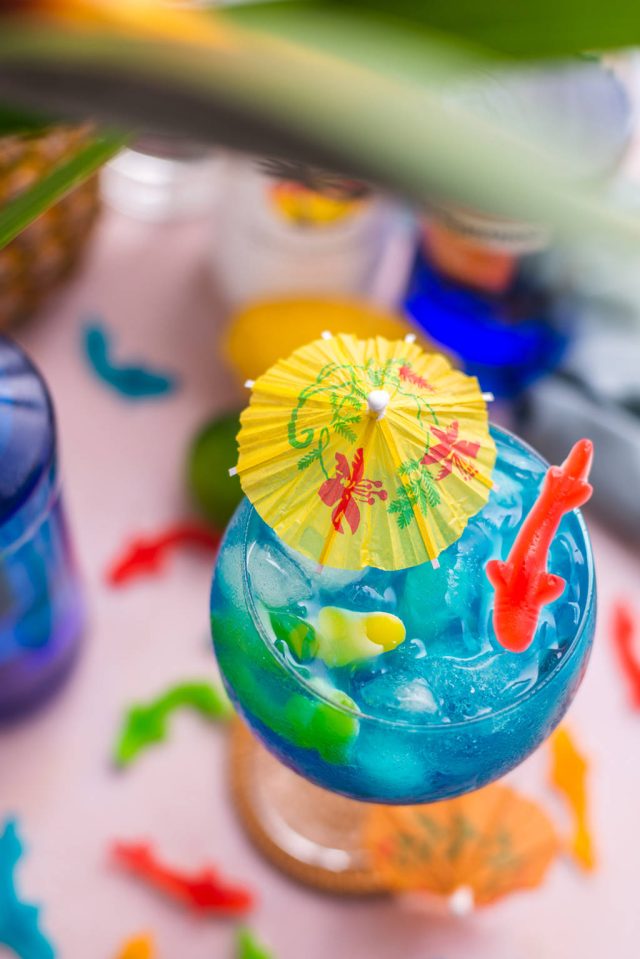 top view of a glass of fish bowl drink cocktail with garnish