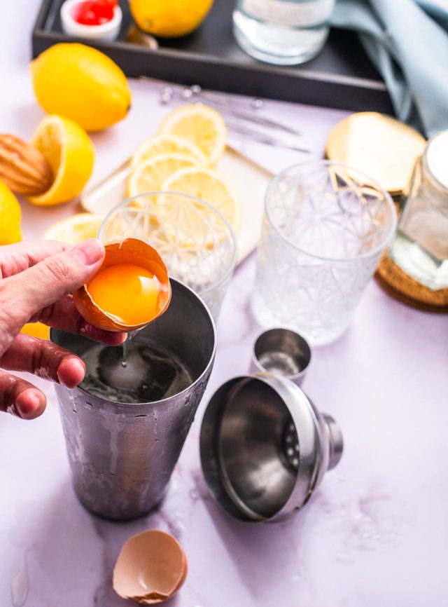 carefully adding the egg white in the cocktail shaker