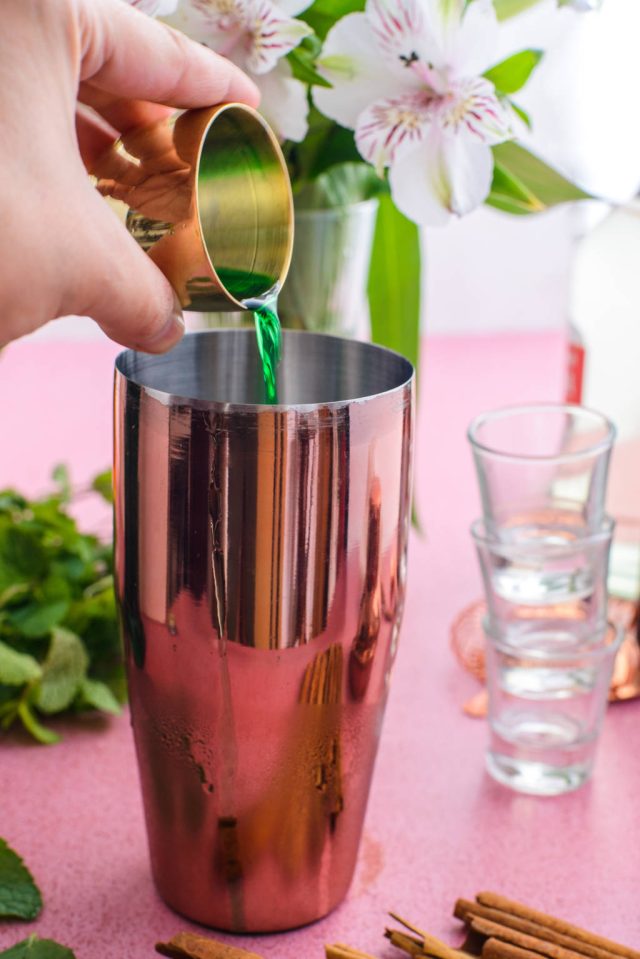 adding Jagermeister into a cocktail shaker