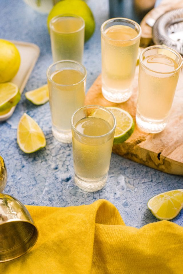 five glasses of Water moccasin shot with lemon background