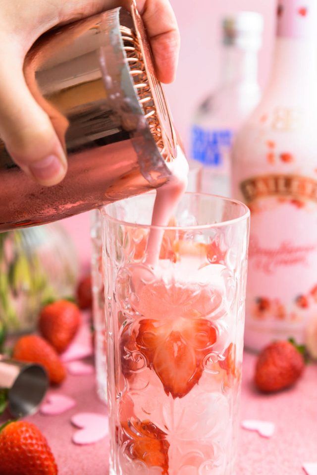 pouring the Baileys strawberries and cream pink recipes to the glass