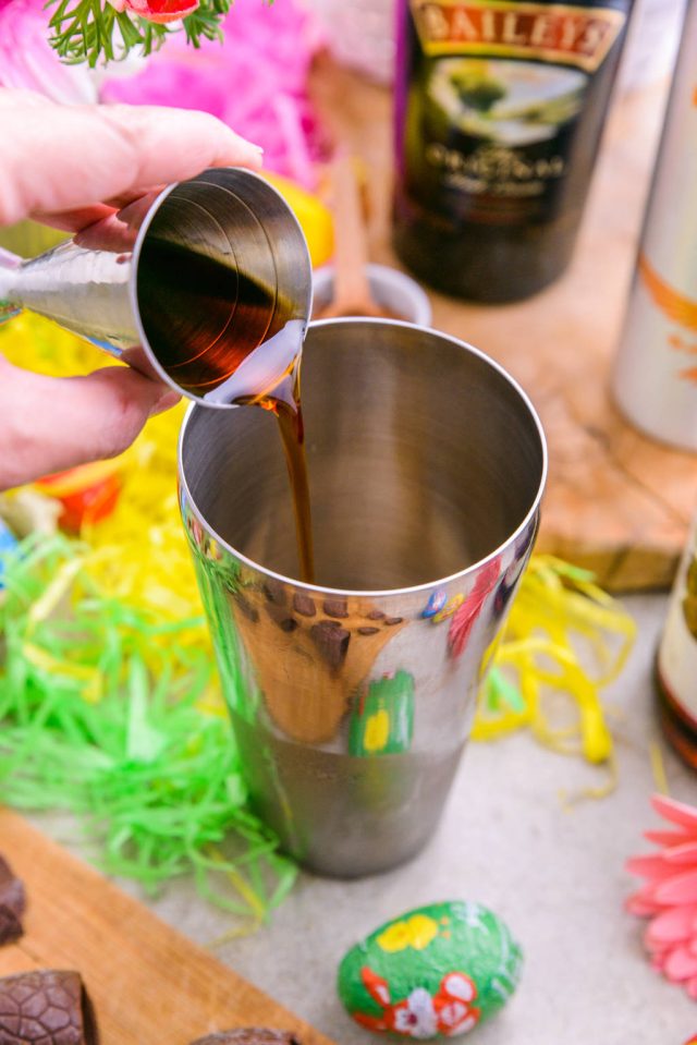 adding the caramel vodka in a cocktail shaker